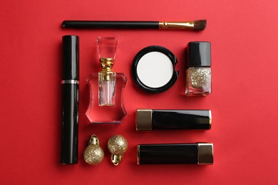 Flat lay composition with decorative cosmetic products on red background. Winter care