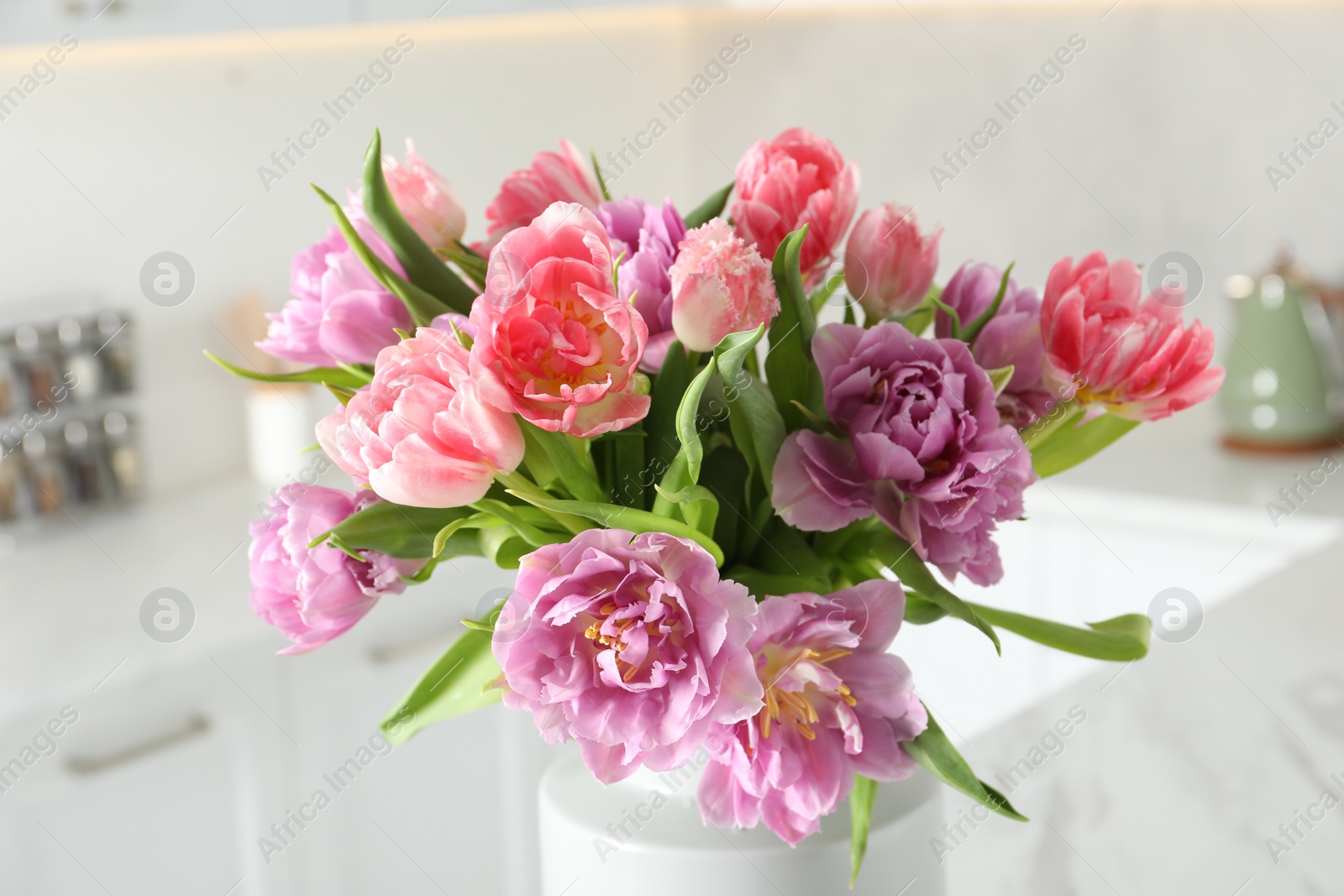 Photo of Beautiful bouquet of colorful tulip flowers indoors, closeup