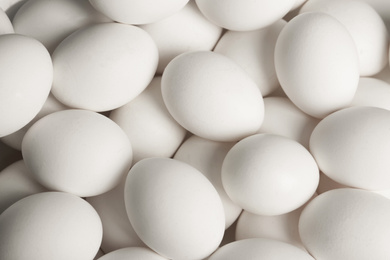 Photo of Fresh raw white chicken eggs as background, top view