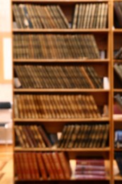 Blurred view of books on shelves in library