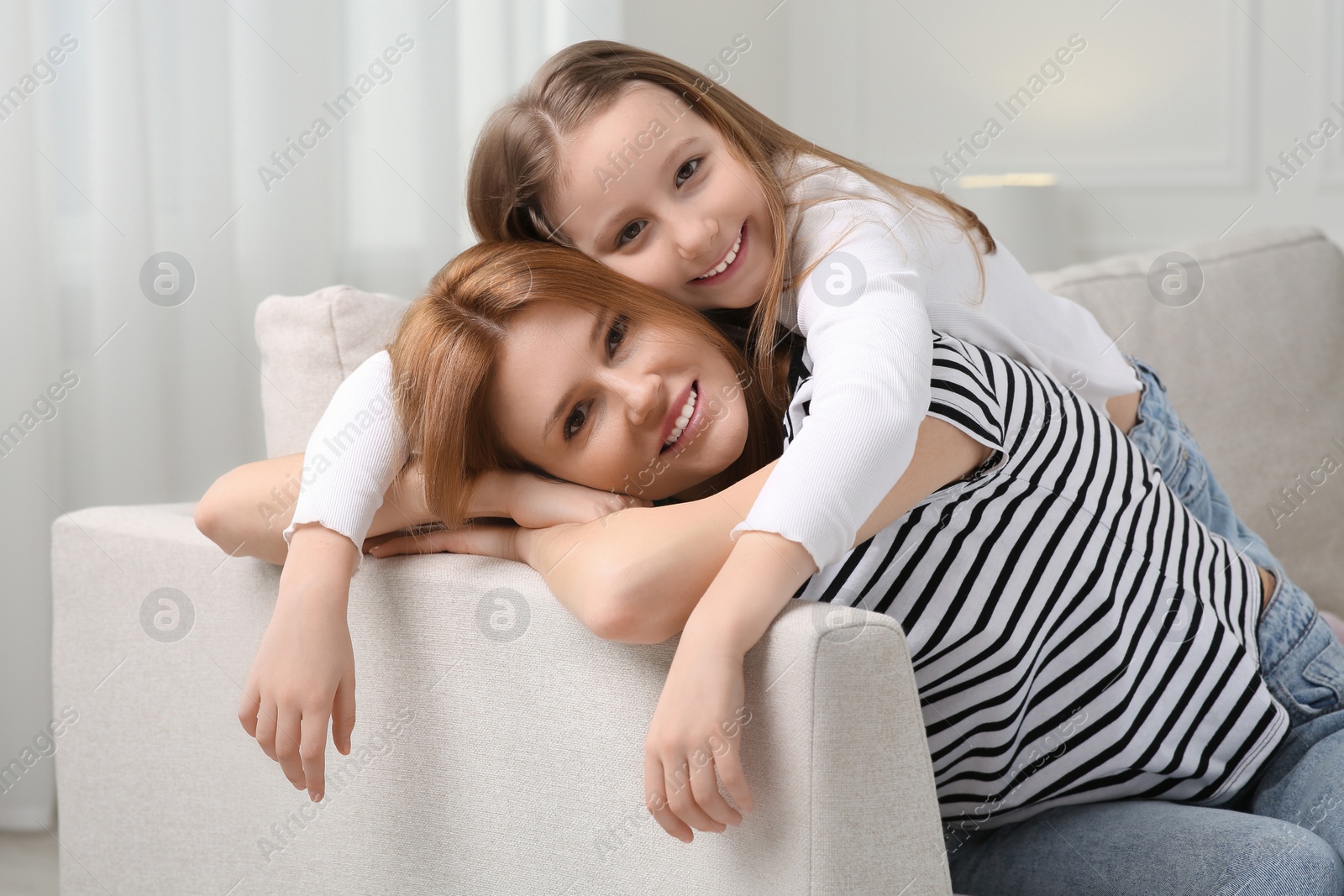 Photo of Mother and her cute daughter spending time together at home