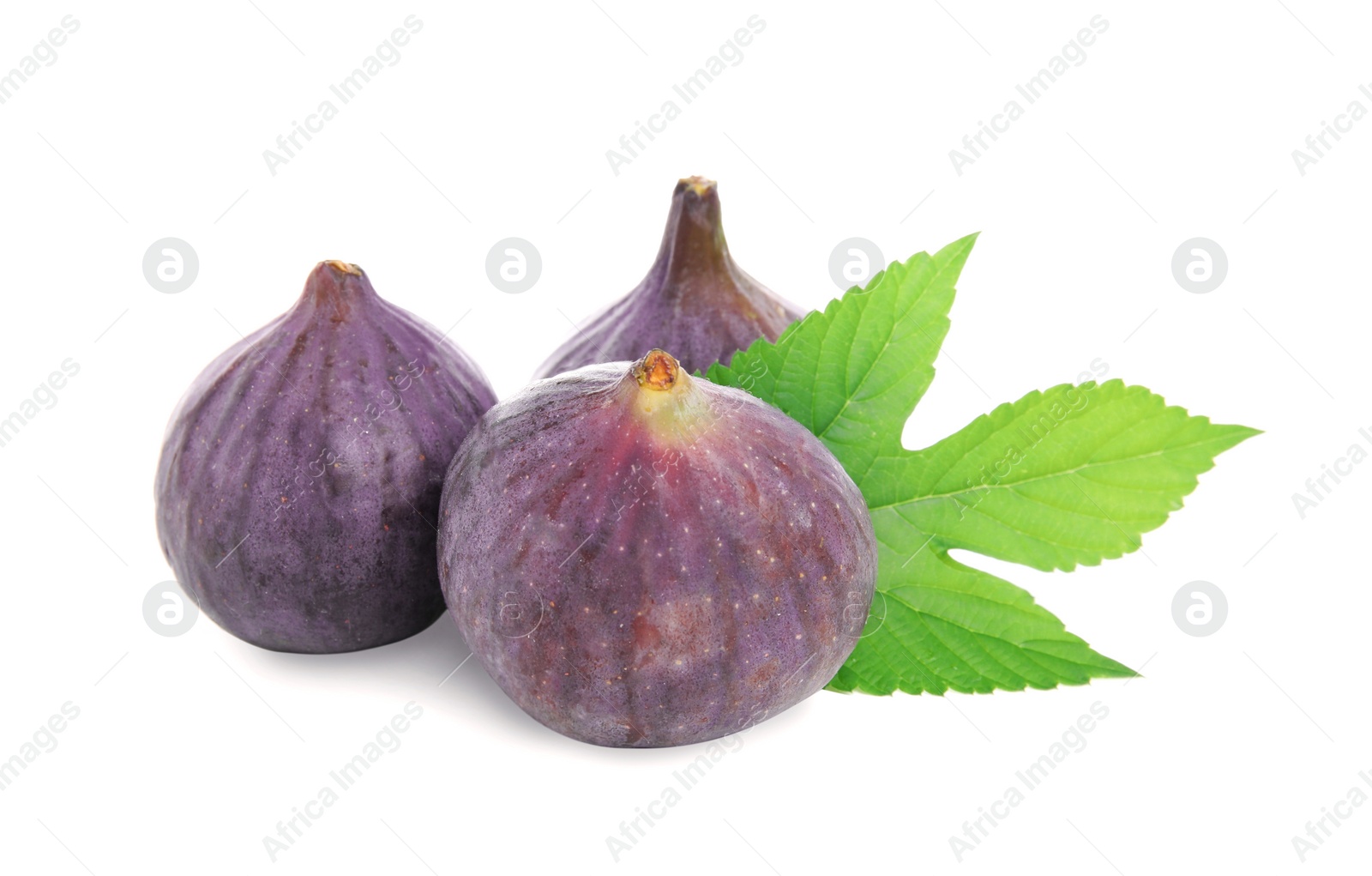 Photo of Whole ripe fresh figs with green leaf isolated on white