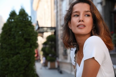 Photo of Portrait of beautiful young woman on city street