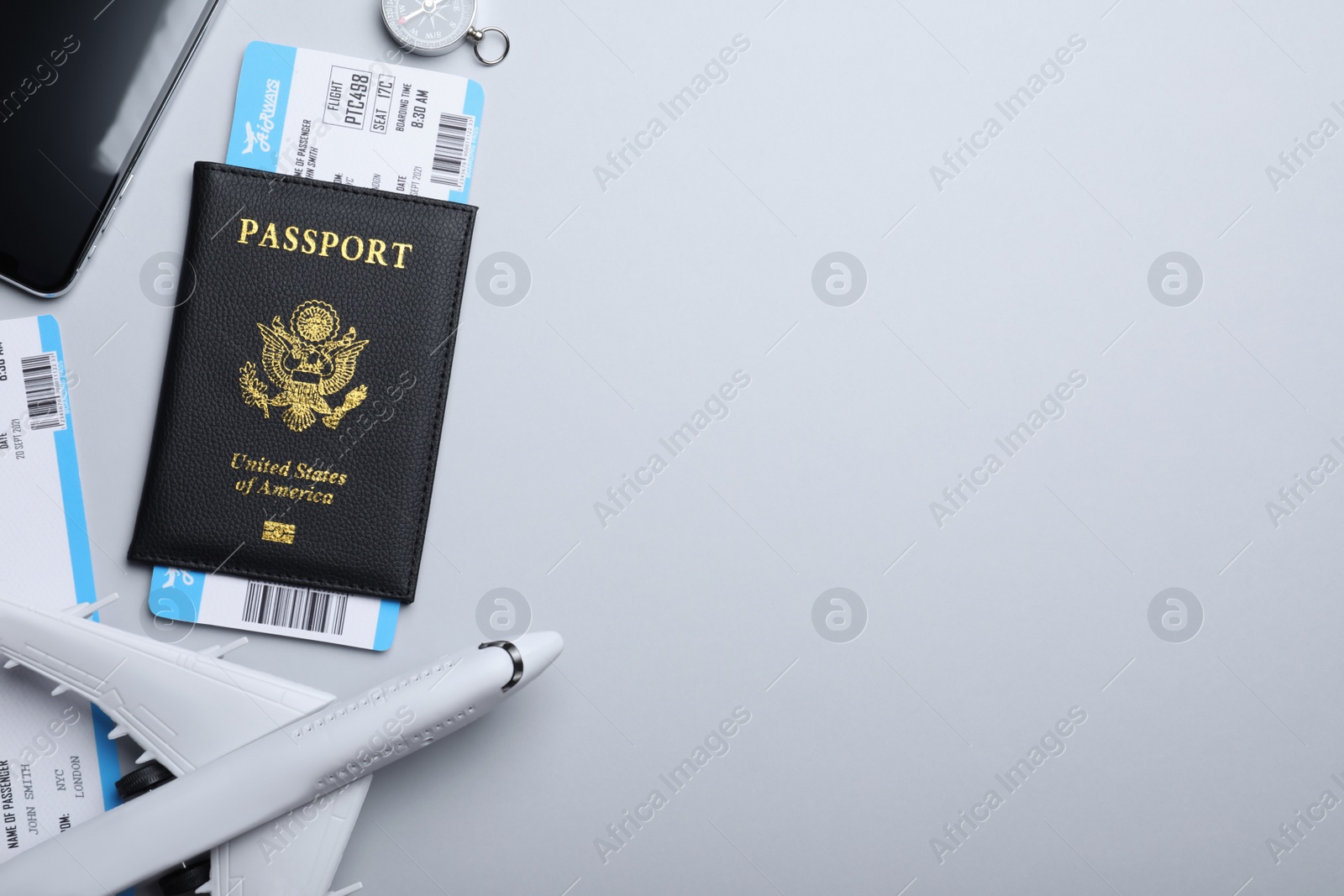 Photo of Flat lay composition with tickets and passport on white background, space for text. Travel agency concept