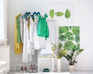 Stylish dressing room interior with clothes rack