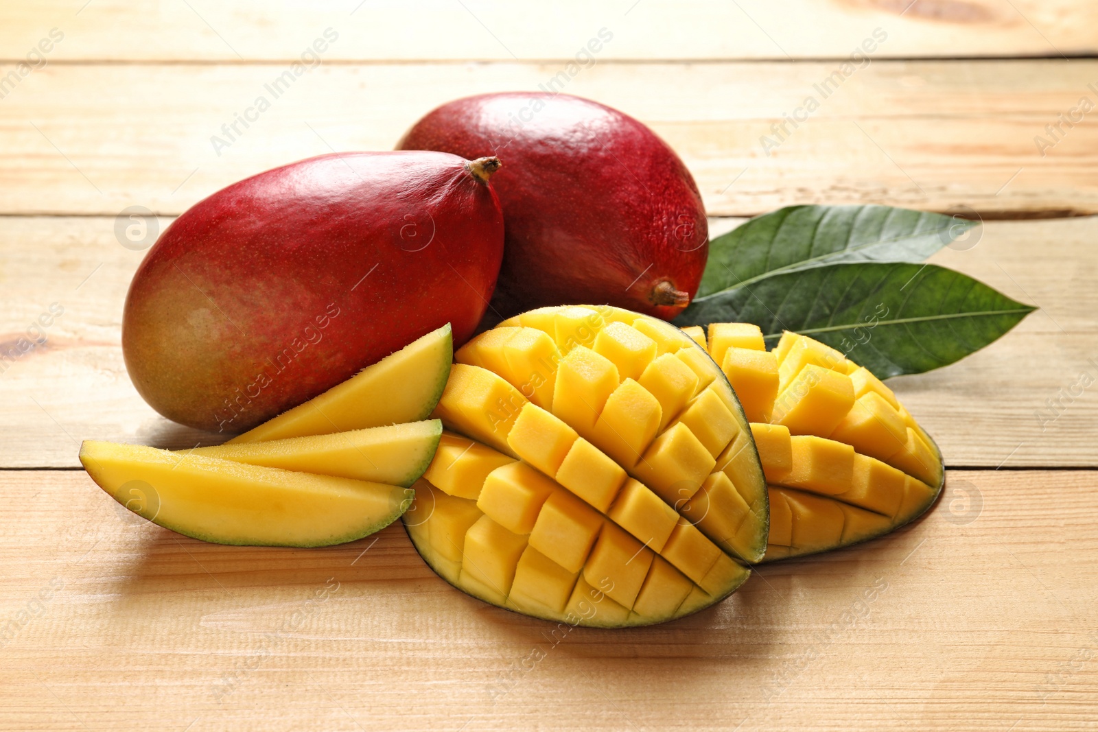 Photo of Composition with fresh mango on light wooden background