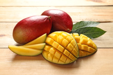 Photo of Composition with fresh mango on light wooden background