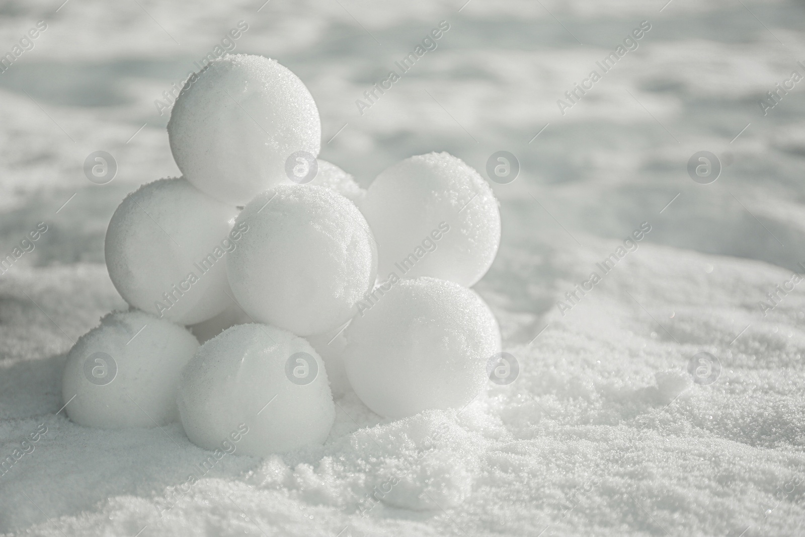 Photo of Perfect round snowballs on snow outdoors, closeup. Space for text