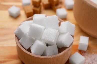 White sugar cubes in bowl on table, closeup