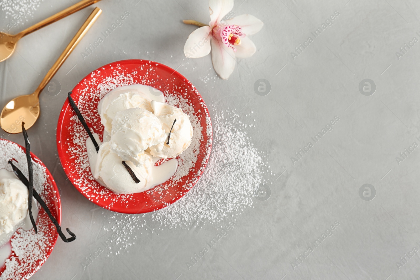 Photo of Plate with tasty vanilla ice cream on grey background, top view