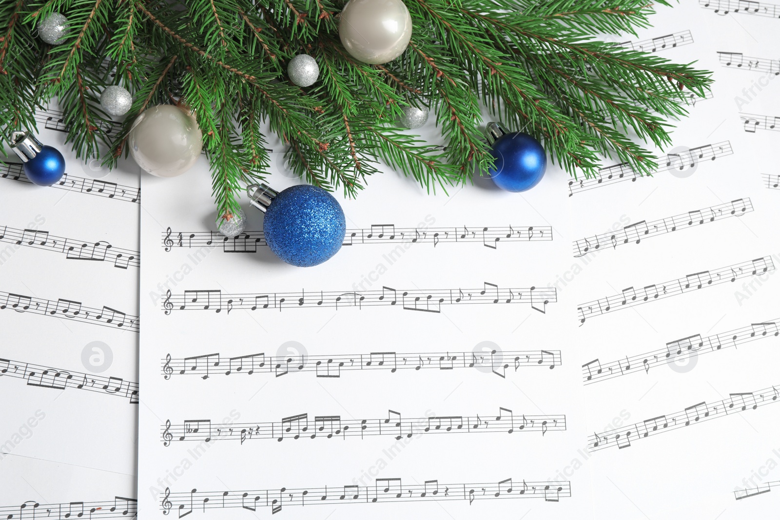 Photo of Flat lay composition with Christmas decorations on music sheets