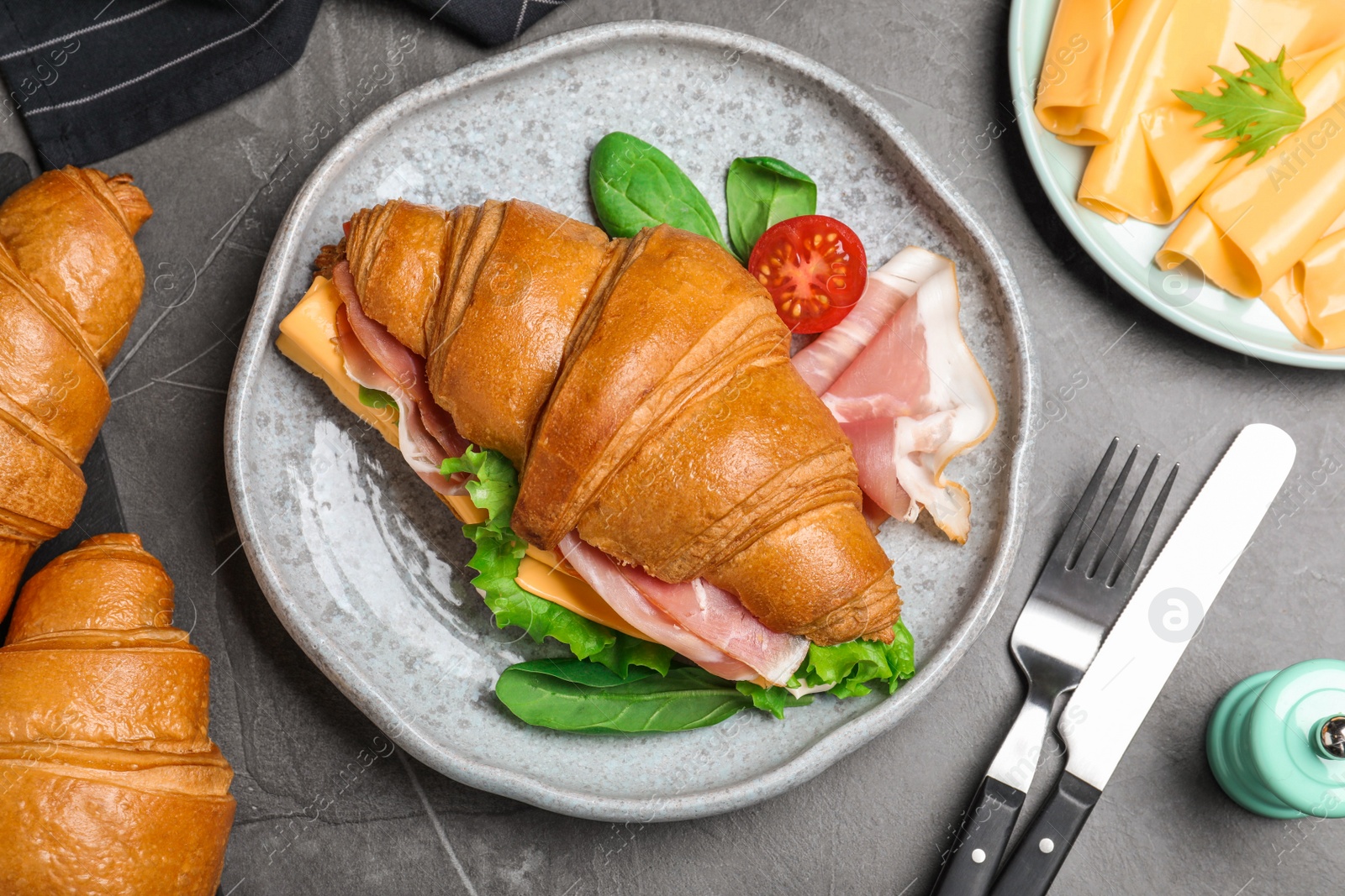 Photo of Flat lay composition with tasty croissant sandwich on grey table