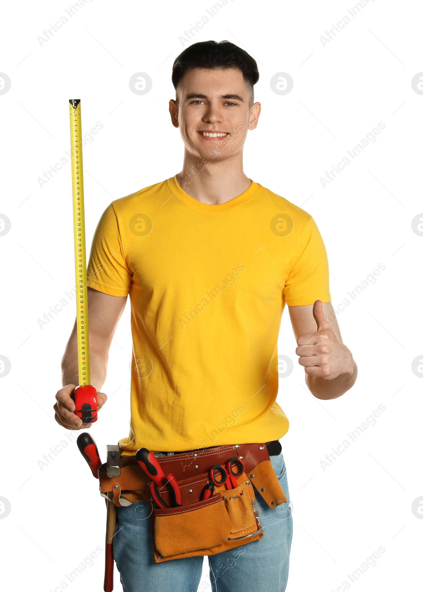 Photo of Handyman with measuring tape and tool belt showing thumb up isolated on white