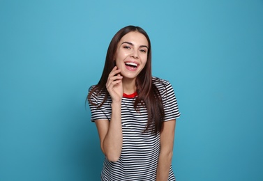 Photo of Portrait of young woman laughing on color background