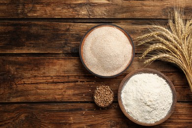 Flat lay composition with wheat flour on wooden table. Space for text