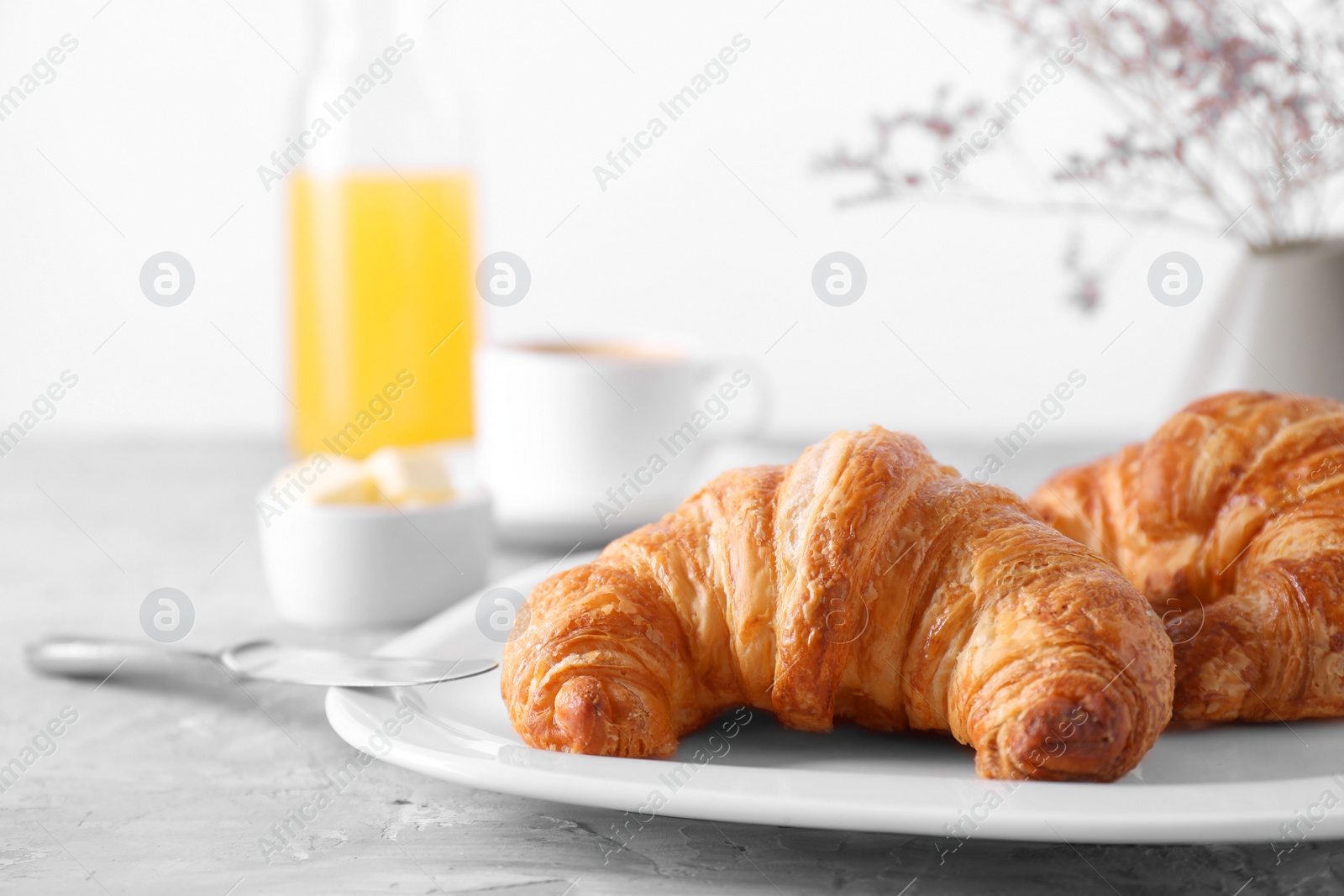 Photo of Tasty breakfast. Fresh croissants on grey table, closeup