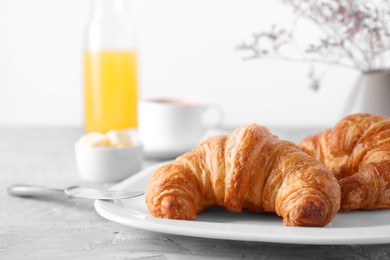 Photo of Tasty breakfast. Fresh croissants on grey table, closeup