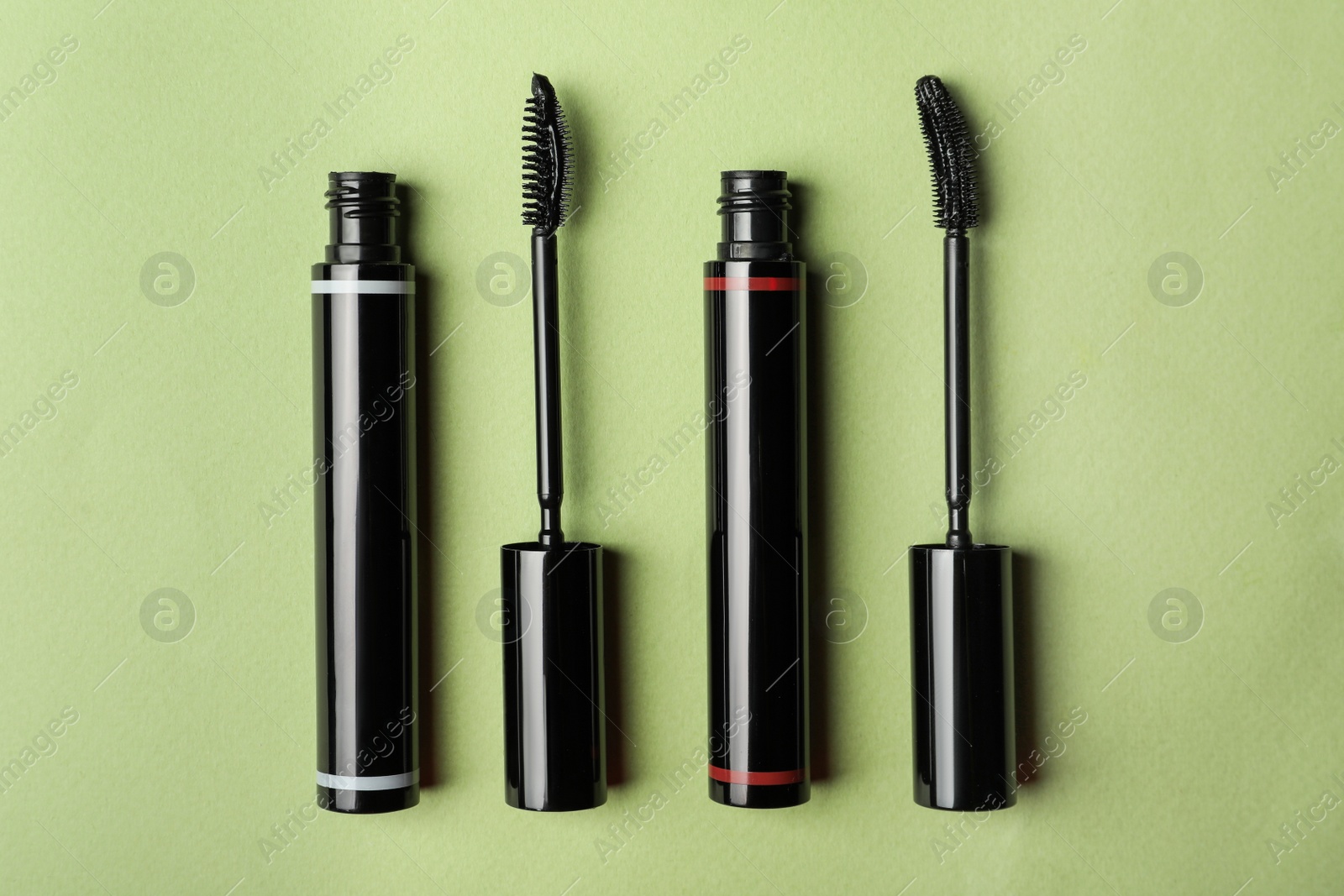 Photo of Different mascaras for eyelashes on light background, flat lay. Makeup product