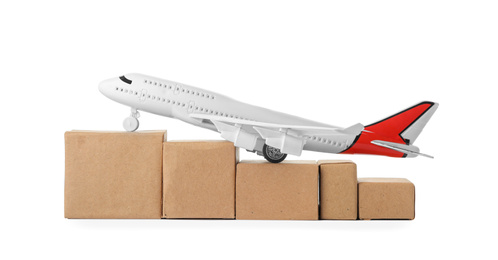 Photo of Toy plane with boxes isolated on white. Logistics and wholesale concept