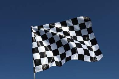 One checkered flag against blue sky outdoors