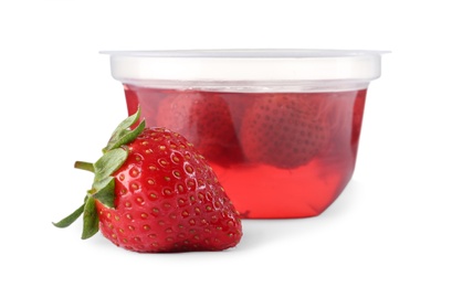 Strawberry and tasty jelly dessert in plastic cup on white background