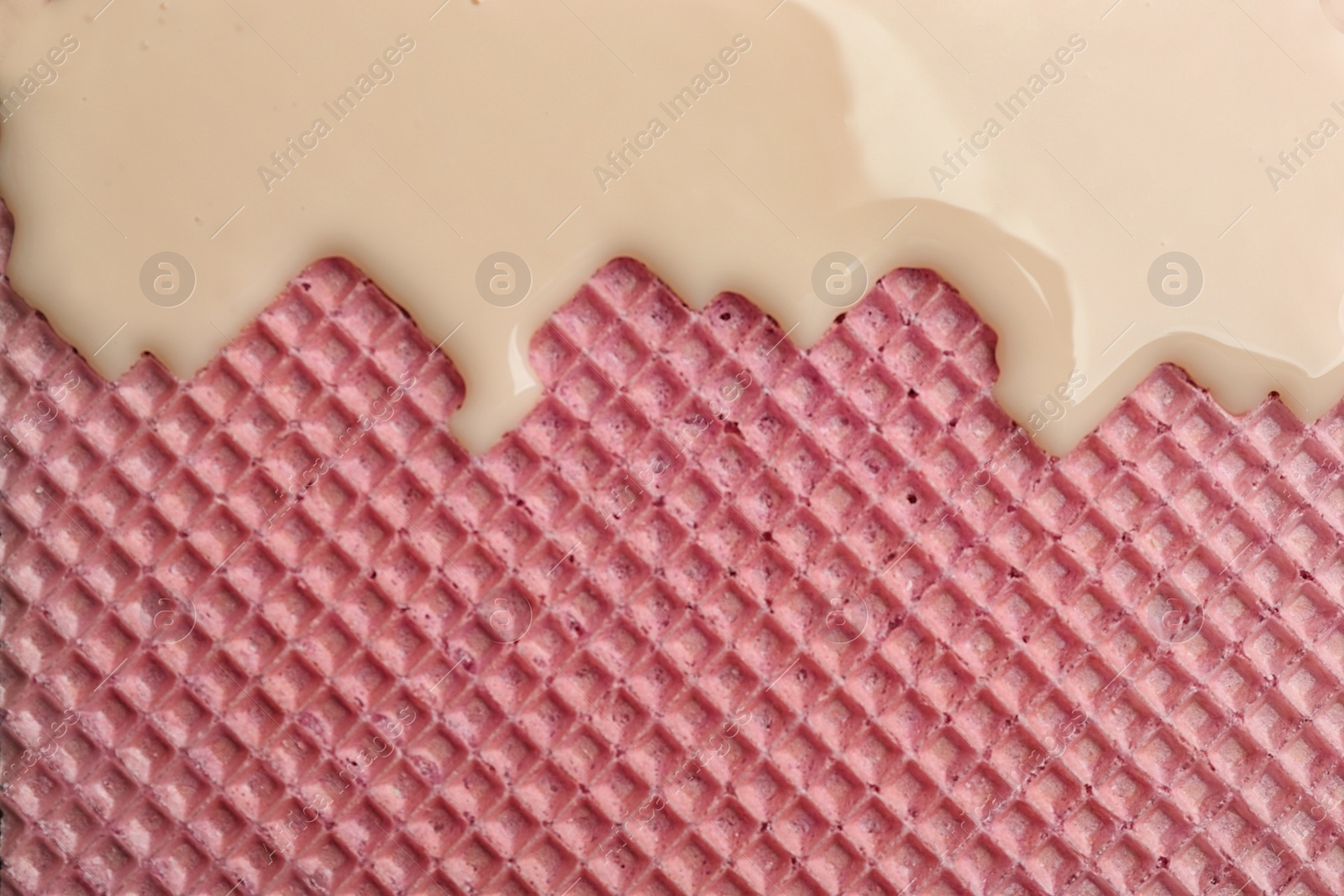 Photo of Hot white chocolate on wafer, closeup. Crispy food