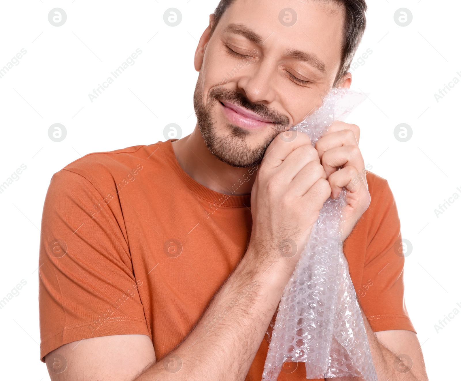 Photo of Man popping bubble wrap on white background, closeup. Stress relief