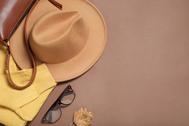 Photo of Flat lay composition with stylish hat on brown  background, space for text