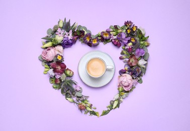 Photo of Beautiful heart made of different flowers and coffee on violet background, flat lay