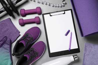 Photo of Clipboard with paper sheet, pen and sports equipment on light gray background, flat lay. Personal training