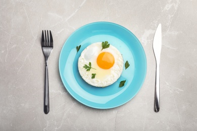 Photo of Fried sunny side up egg served on table, flat lay