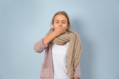 Photo of Girl coughing on light background