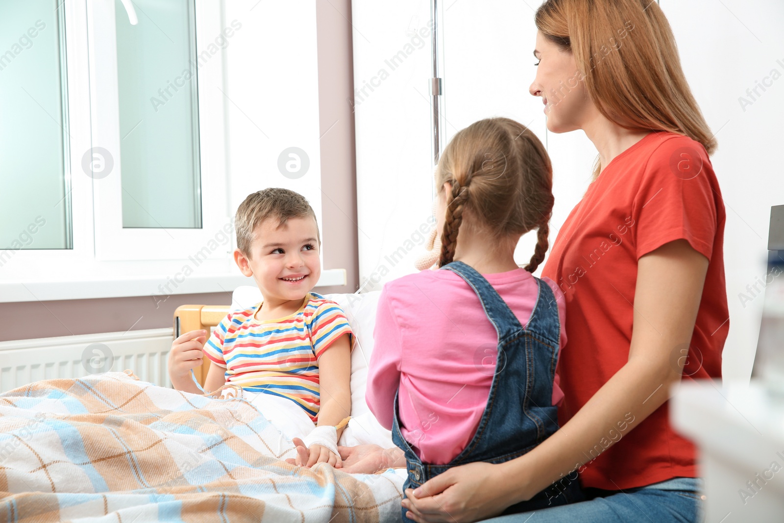 Photo of Happy family visiting little child in hospital