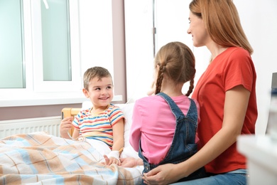 Happy family visiting little child in hospital