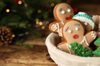 Photo of Delicious homemade Christmas cookies in bowl against blurred festive lights, closeup. Space for text