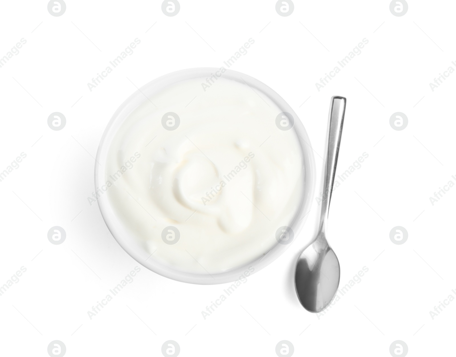 Photo of Tasty organic yogurt in bowl and spoon isolated on white, top view