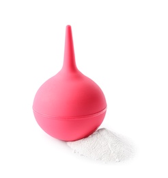 Photo of Pink enema and soda powder on white background