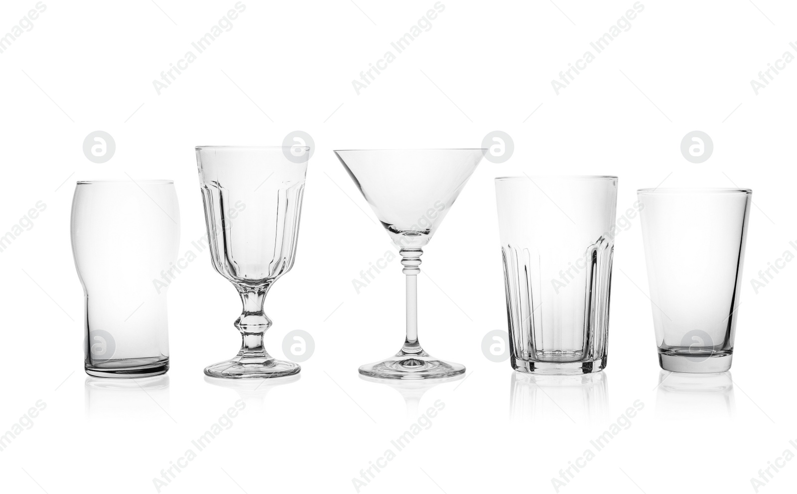 Photo of Set of empty glasses for different drinks on white background