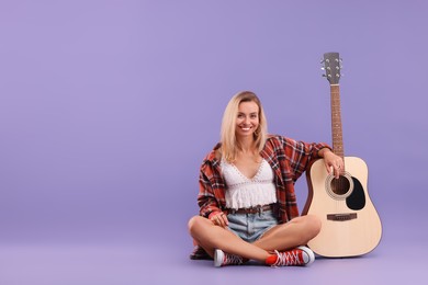 Photo of Happy hippie woman with guitar on purple background. Space for text