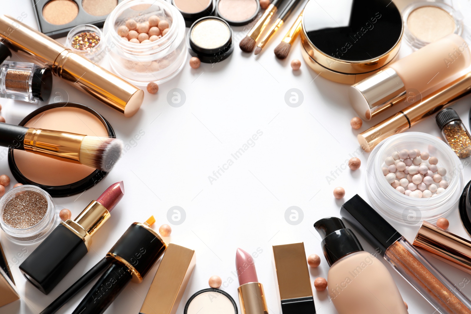 Photo of Frame made of different luxury makeup products on white background. Space for text