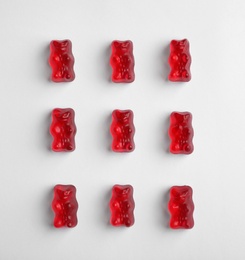 Photo of Delicious color jelly bears on white background, top view