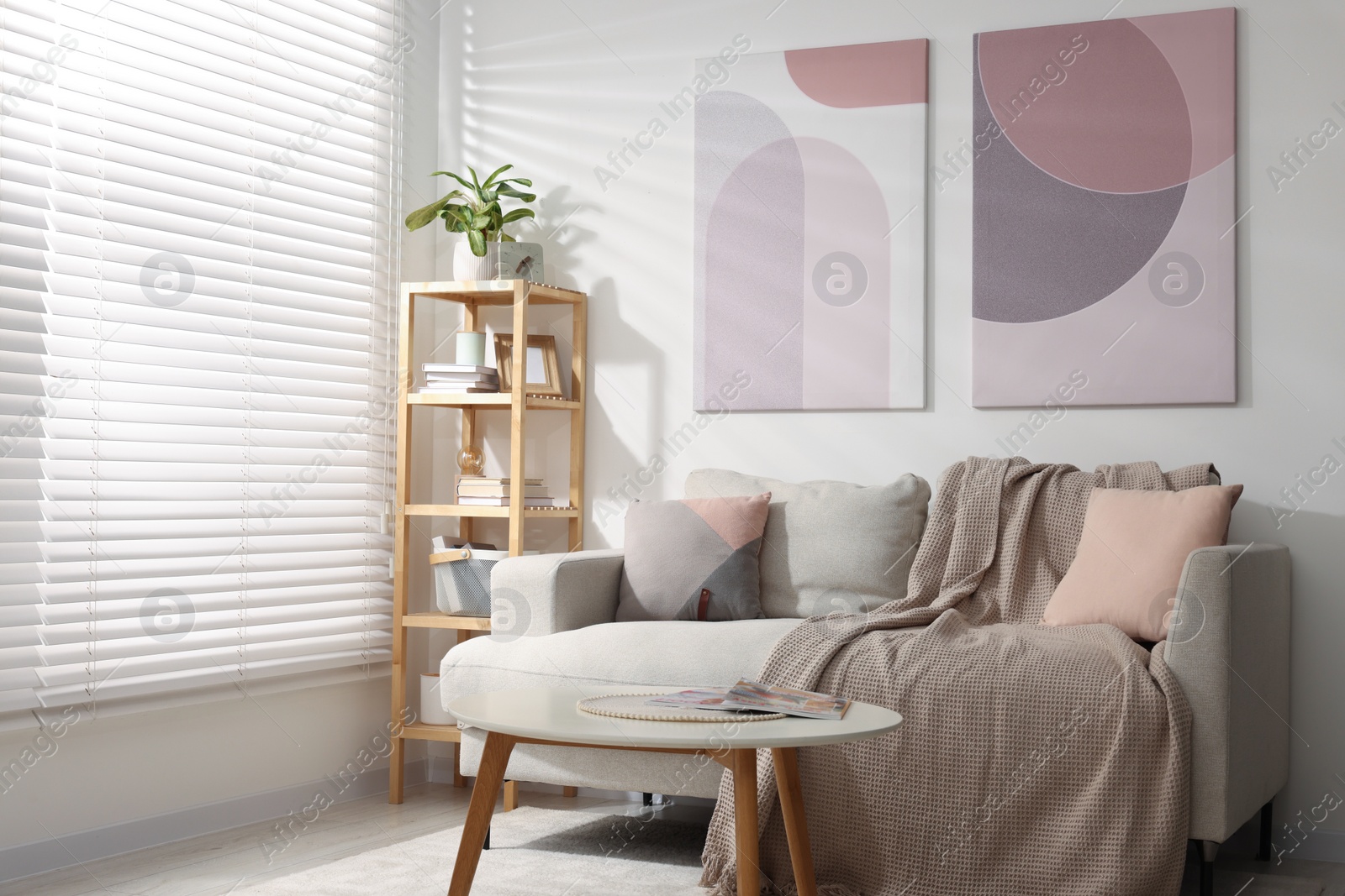 Photo of Stylish living room interior with sofa, coffee table and wooden shelf