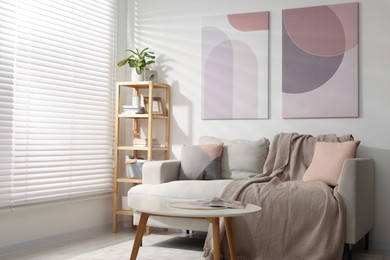 Stylish living room interior with sofa, coffee table and wooden shelf