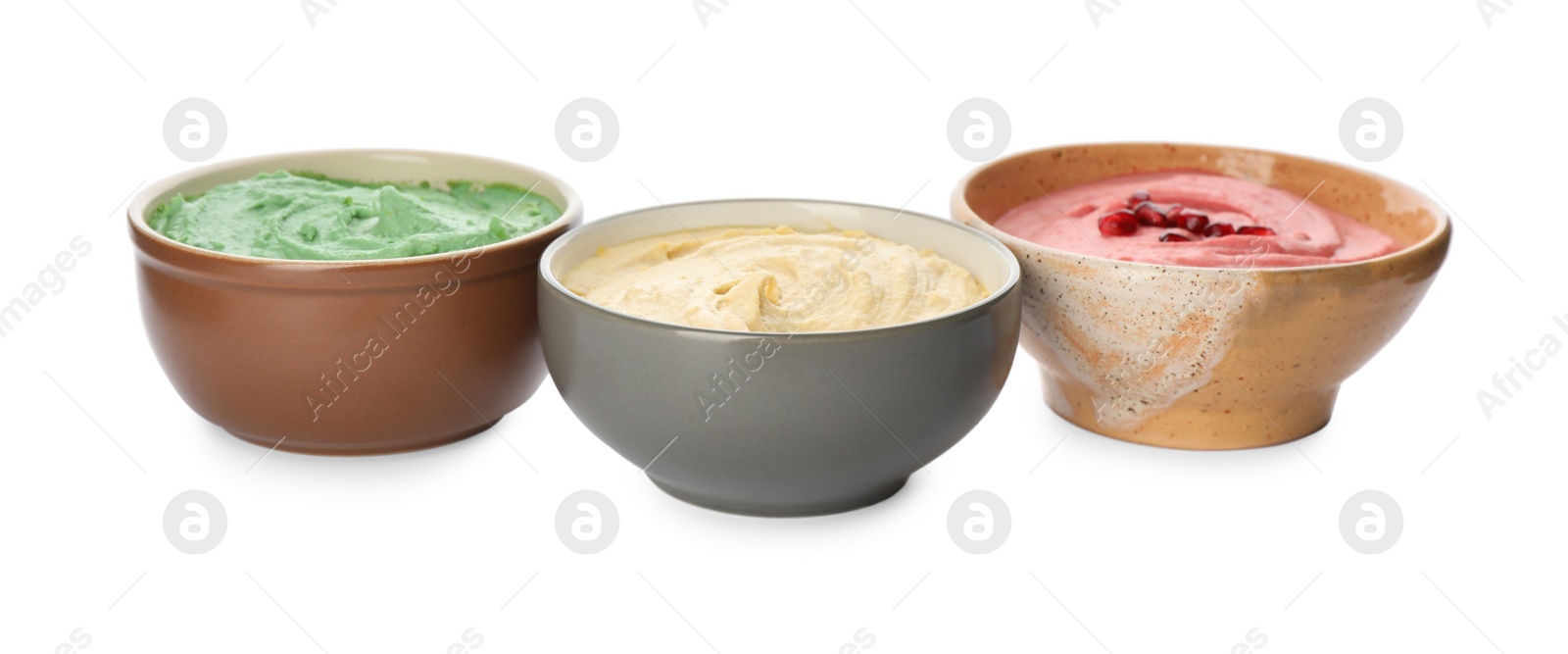 Photo of Different kinds of tasty hummus in bowls on white background