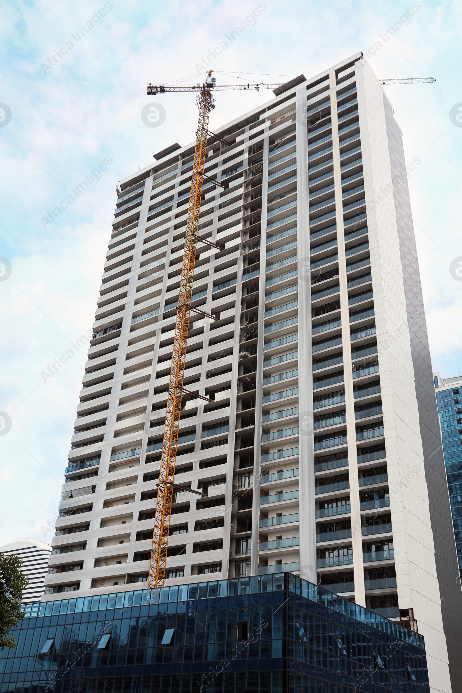 Photo of Construction site with tower crane near unfinished building