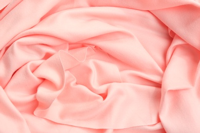 Photo of Elegant peach cloth as background, closeup view