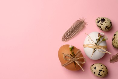 Photo of Festively decorated eggs on pink background, flat lay and space for text. Happy Easter