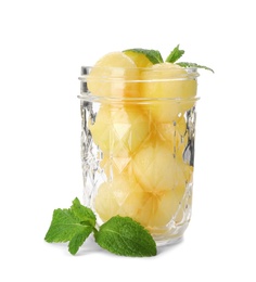 Jar with melon balls on white background