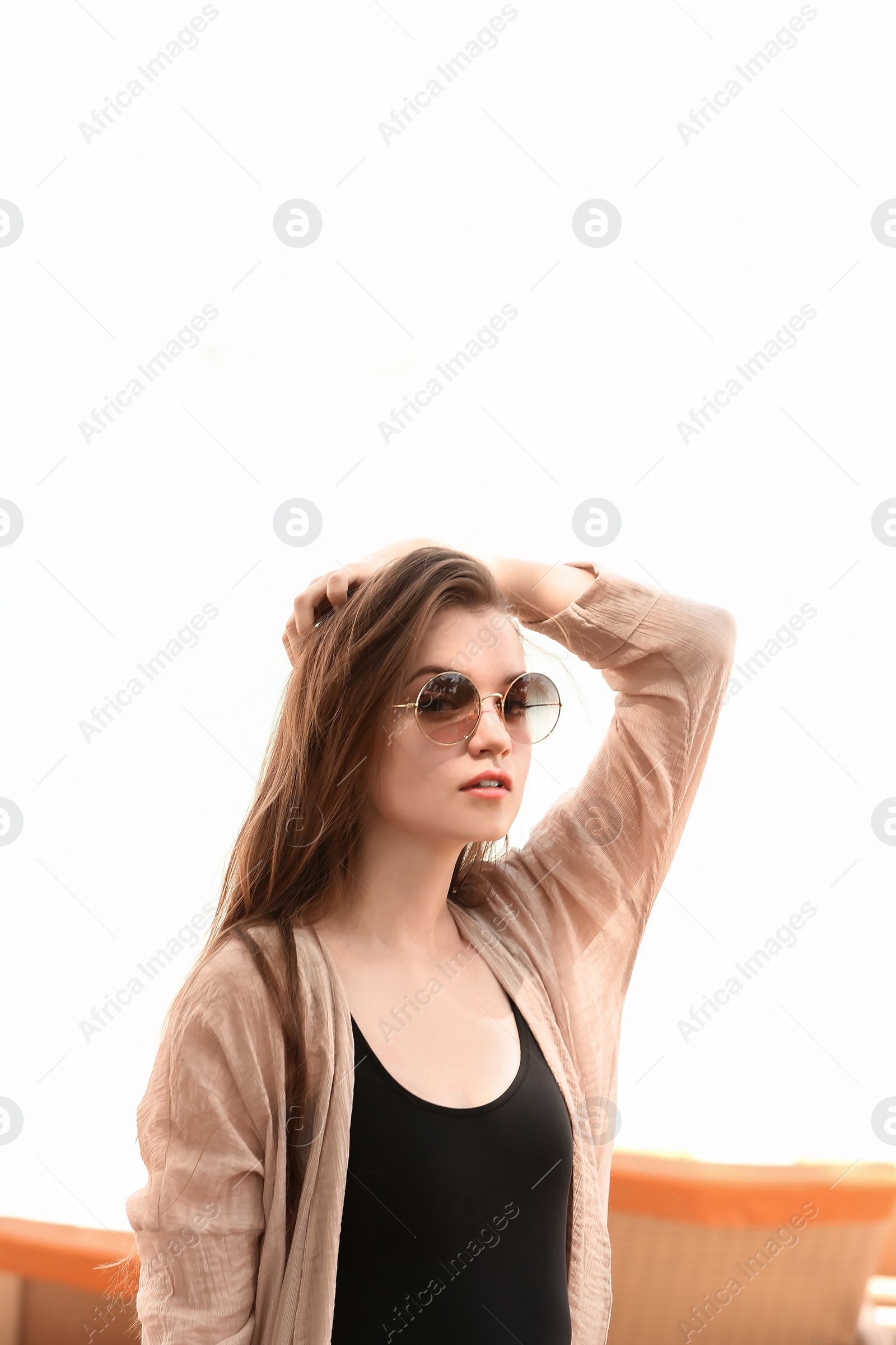 Photo of Beautiful young woman in swimsuit at resort