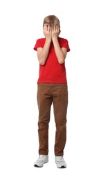 Boy covering face with hands on white background. Children's bullying